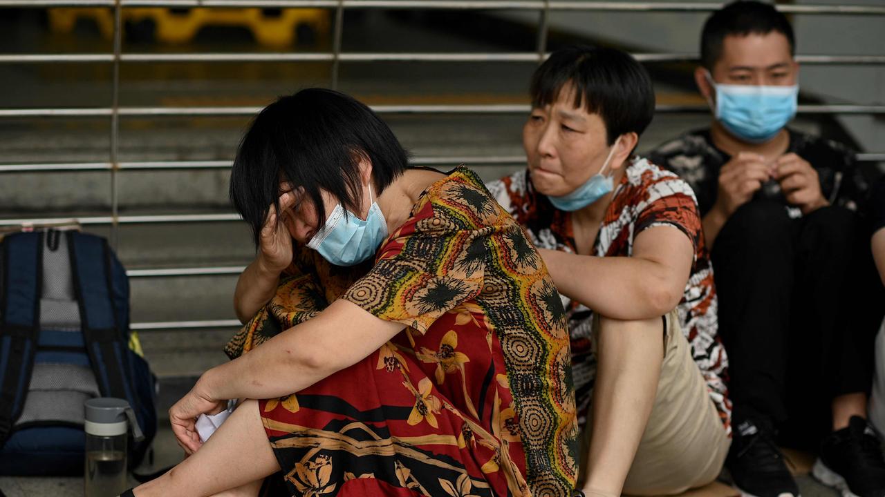 A woman crying as she and other people gather at the Evergrande headquarters in Shenzhen, southeastern China. Picture: Noel Celis / AFP