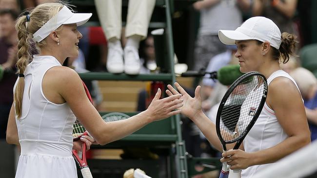 Australia’s Ash Barty, right, shakes hands with Britain’s Harriet Dart following her third round victory at Wimbledon. Picture: AP