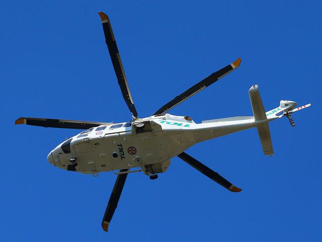 Ambulance helicopter hovering near Academy of Sport, Wakehurst Parkway Narrabeen.