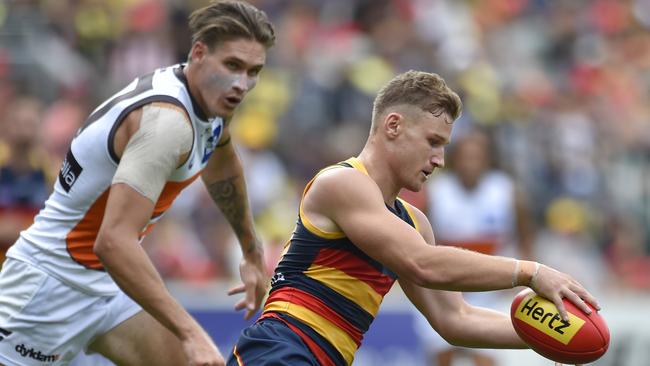 Dominant force ... Rory Laird breaks away from the Giants’ Rory Lobb at Adelaide Oval. Picture: David Mariuz (AAP)