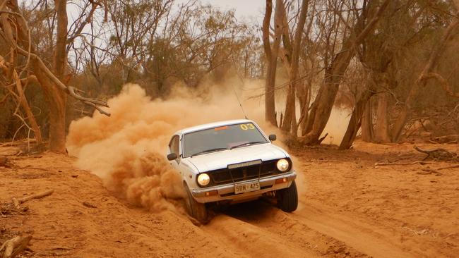 Steve and Lucas Dent plow through thick bull dust on a remote stretch of the Strzelecki Track. Picture: Roderick Eime