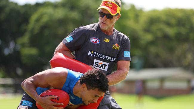 Damien Hardwick holds off Malcolm Rosas during a Gold Coast training session. Picture: Chris Hyde/Getty Images