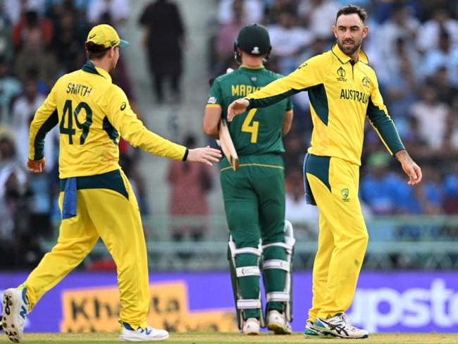 Glenn Maxwell (R) celebrates with Steve Smith (L) after taking the wicket of South Africa's Quinton de Kock at the 2023 Cricket World Cup. Picture: Sajjad Hussain/AFP