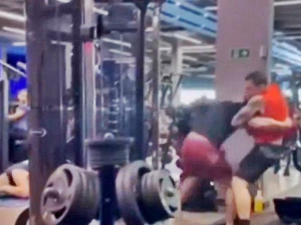 Two men trade MMA-style punches and kicks in busy gym. Picture: Jam Press