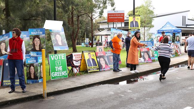 SYDNEY, AUSTRALIA - MAY 10: Volunteers hand out voting information leaflets to people as they arrive at a voting centre at the Homebush West Community centre on May 10, 2022 in Sydney, Australia. Pre-polling is available to Australians who are unable to get to a polling station on election day, May 21, 2022. (Photo by Mark Kolbe/Getty Images)