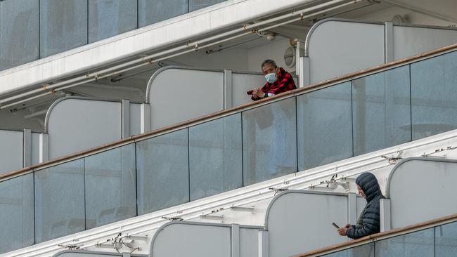 Quarantined passengers aboard the Diamond Princess cruise ship, where 61 passengers are confirmed to be infected with coronavirus as Japanese authorities continue screening people.