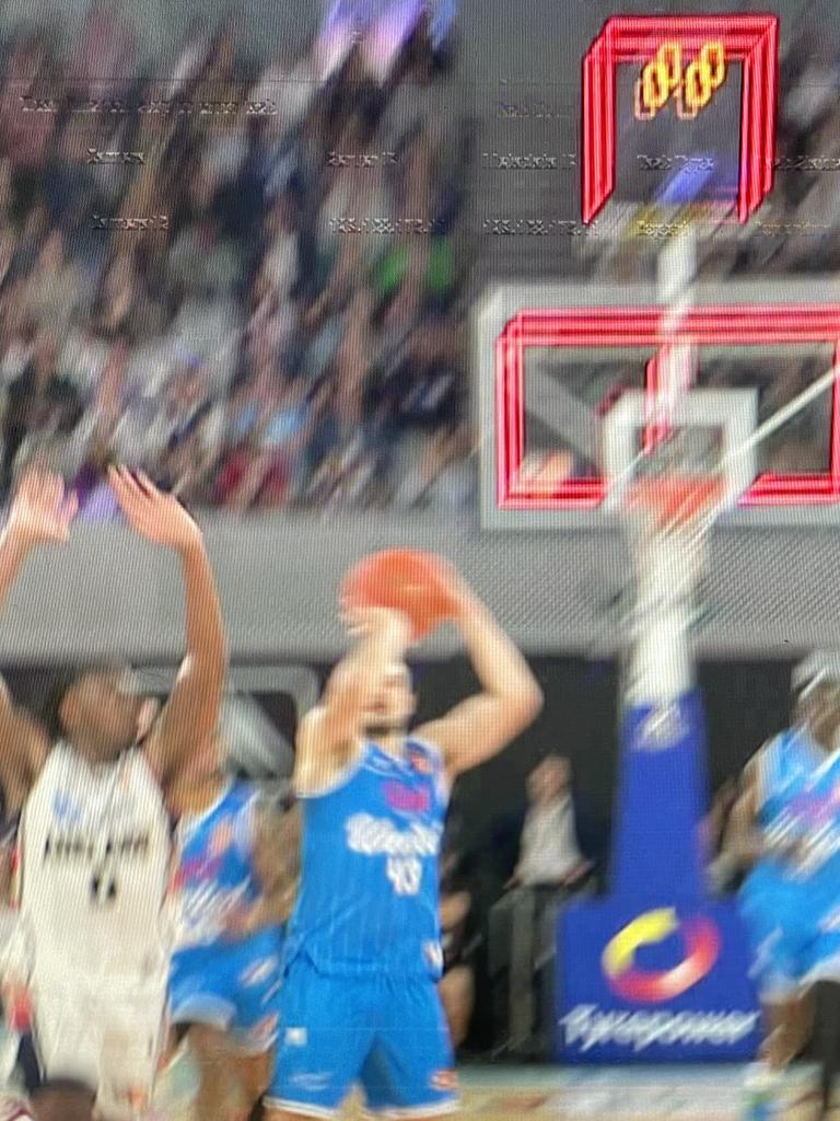 His half-court monster fired up the crowd but sadly the official clock is the one above the rim (see above).