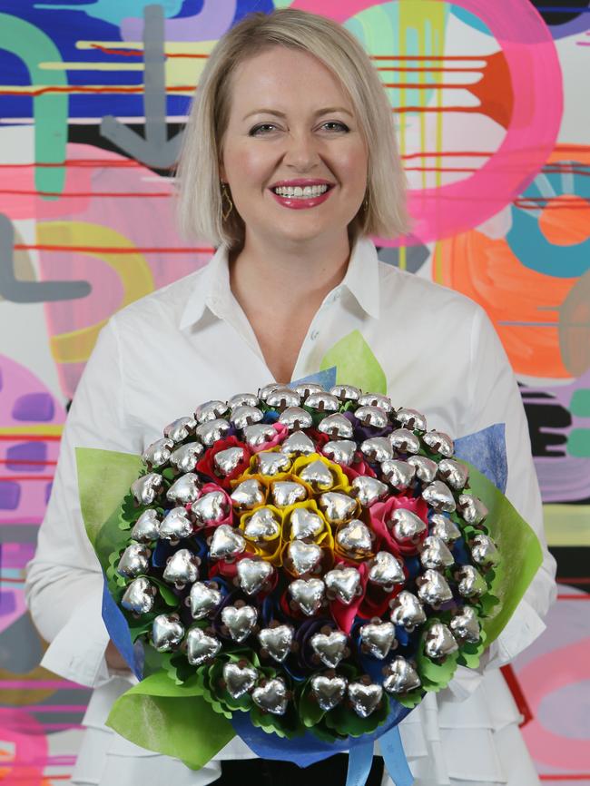 Edible Blooms founder Kelly Jamieson with some of her edible creations in the Keswick HQ. The business is celebrating its expansion overseas. (AAP/Emma Brasier)