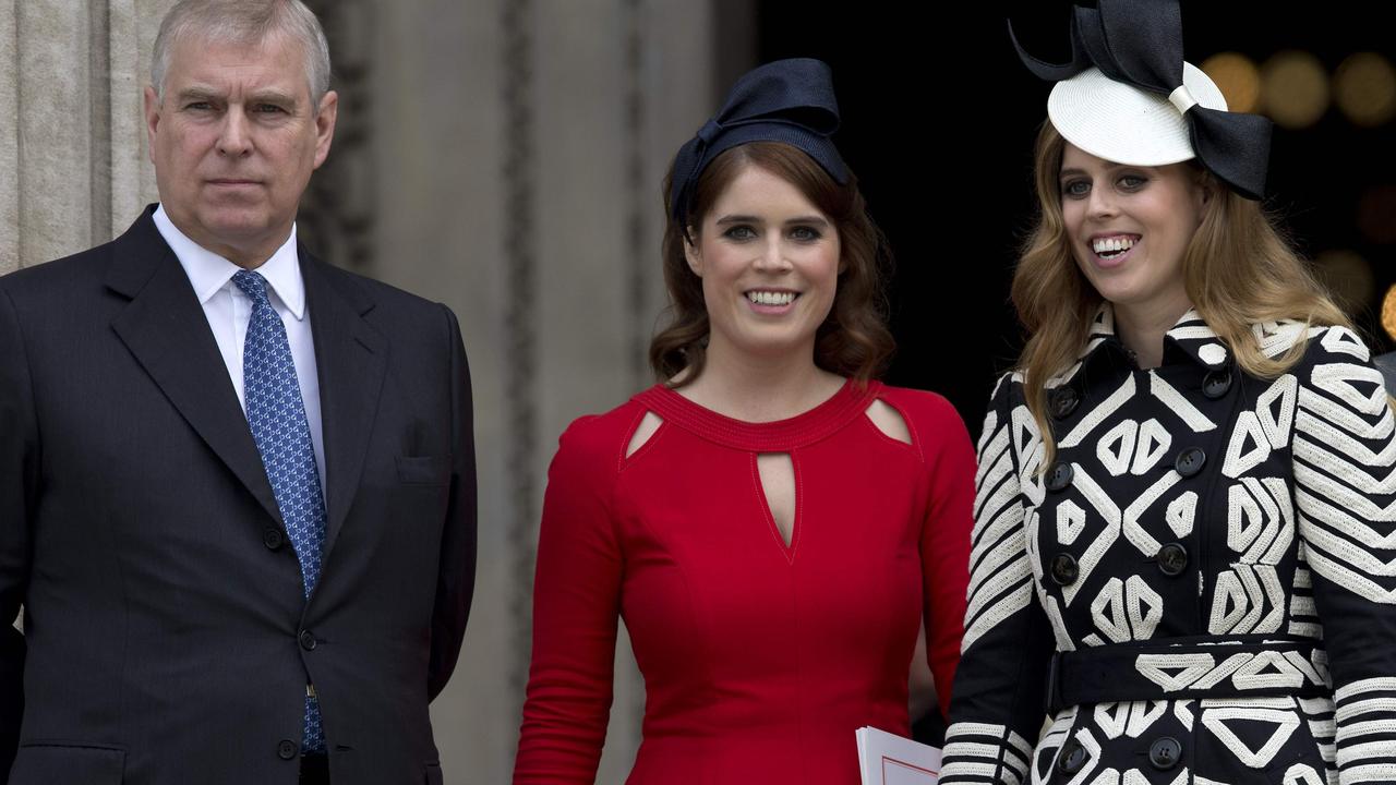 Prince Andrew with his daughters Eugenie (centre) and Beatrice. Picture: AFP/Justin Tallis