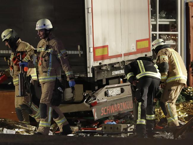 Firefighters inspect the site after a truck ran into a crowded Christmas market and killed several people in Berlin, Germany on December 19, 2016. Picture: AP