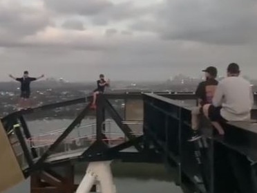 A group of boys posed for photos on highrise scaffolding in Rhodes, Sydney.