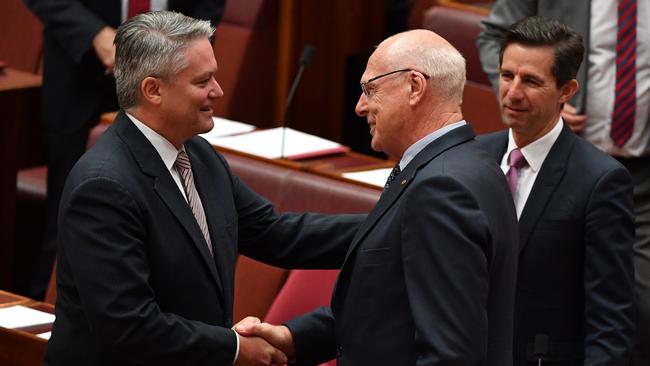 Mathias Cormann congratulates Liberal Senator Jim Molan after his swearing in ceremony. Picture: AAP