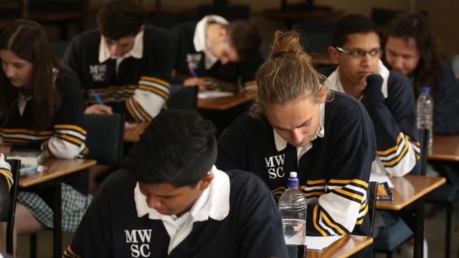 Students at Mount Waverley senior school after English VCE exam.Caleb Benson ponders his English paper.Picture: Stuart Milligan