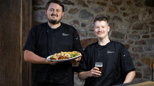 The Macclesfield Hotel’s senior chef Anselmo Massaro with fellow chef Chappo holding the chicken ploughman’s schnitzel. Picture: Emma Brasier