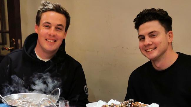 Jordan Hellens (left) having dinner with his brother Braidy (right) while in China. Supplied.