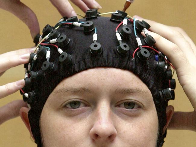 Dr Elaine Mulcahy wearing wired up ‘thinking cap’ connected to computer. The device records brain waves during a medical research test at Sydney University back in 2002.