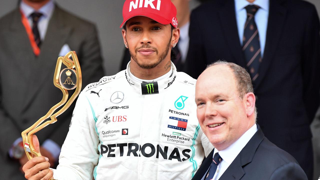 Lewis Hamilton receives his trophy by Prince Albert II of Monaco.