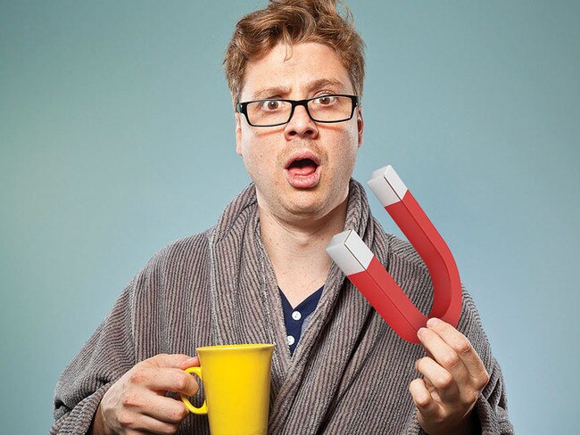 Nerdy guy looking like he's just taken a sip of tea or coffee in the early hours of the morning. He's wearing a dressing gown and is still in his pyjamas having just gotten out of bed. Something he's seen or heard or tasted has surprised and confused him.