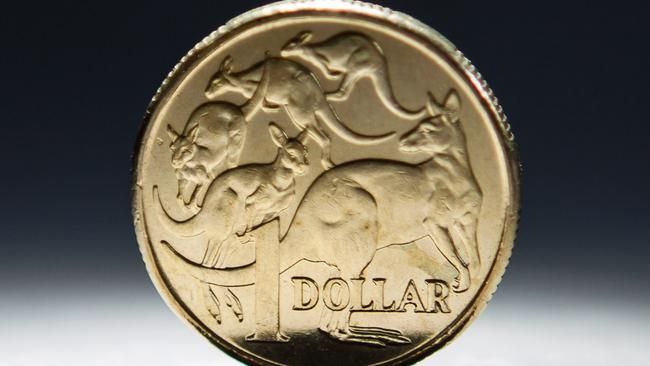 An Australian one-dollar coin is arranged for a photograph in Sydney, Australia, on Wednesday, April 17, 2013. Direct trading between the Australian dollar and yuan started on April 10. Photographer: Ian Waldie/Bloomberg