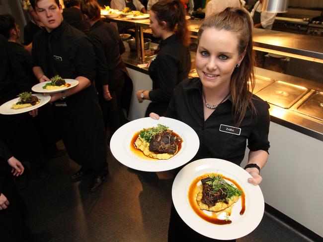 TAFE student Zara Stopford prepares to serve lunc at the Friends of Clifford Craig Medical Trust Melbourne Cup function in Launceston. Picture: CHRIS KIDD