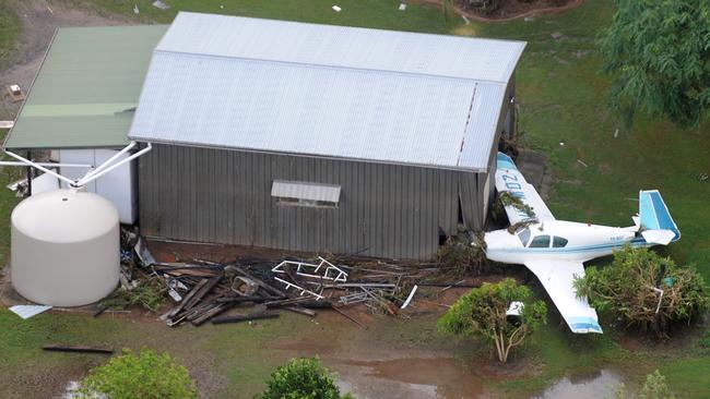 A light aircraft sits damaged after being swept away in flood waters in Grantham, Wednesday, Jan. 12, 2011. Picture: AAP Image/Dave Hunt