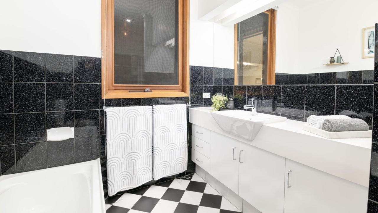 Inside the bathroom which includes a mix of old and new – featuring a retro floor.