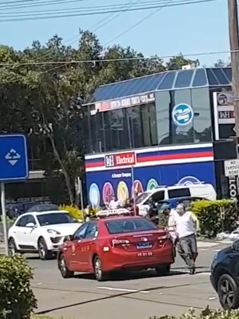 Vision stills show the moment a man carjacks a cab outside Fitness First in Sydney's Rockdale. Picture: Abbas Salim