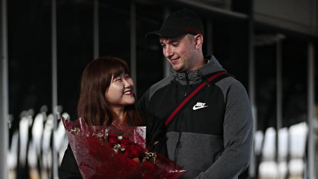 Hye Young Moon, 27, with fiance David Frisken, 25, for the first time in two years at Sydney International airport on November 1 2021. Picture: Adam Yip