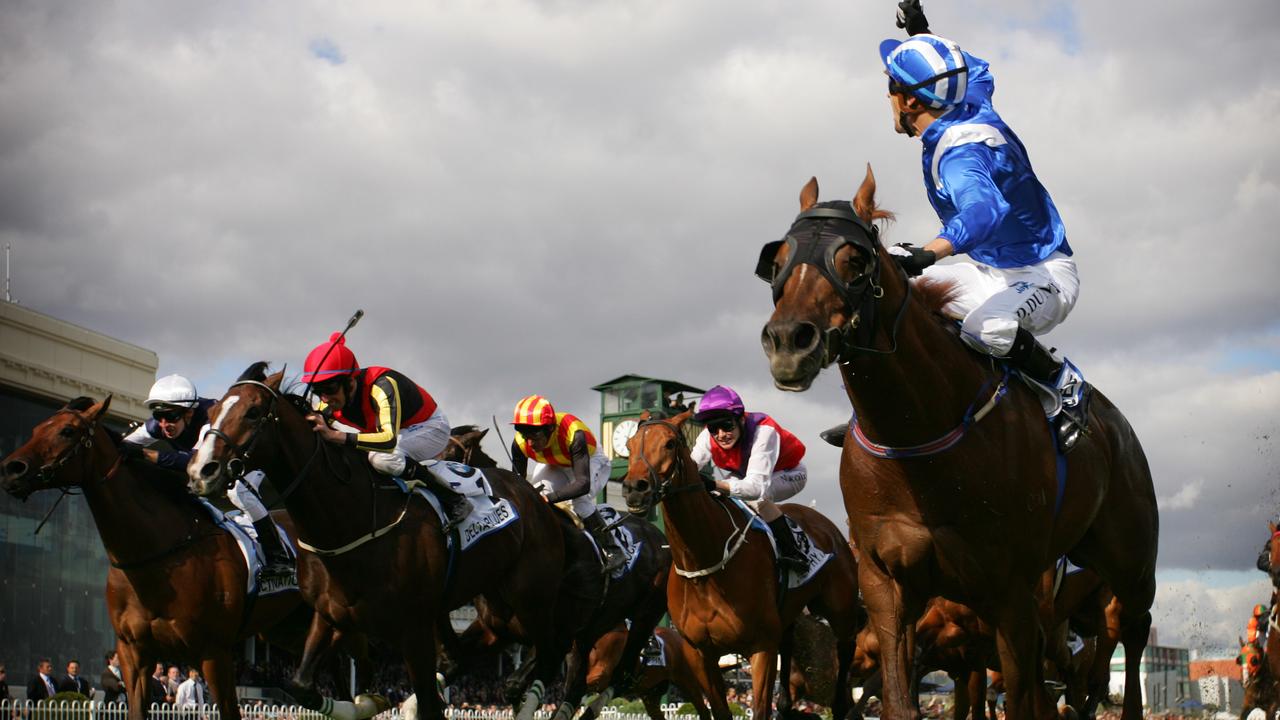 21 Oct 2006 Caulfield Races-  Jockey Dwayne Dunn on Tawqeet waving the whip as he holds off Delta Blues on the line to win in the BMW Caulfield Cup Race 8. sport horseracing action