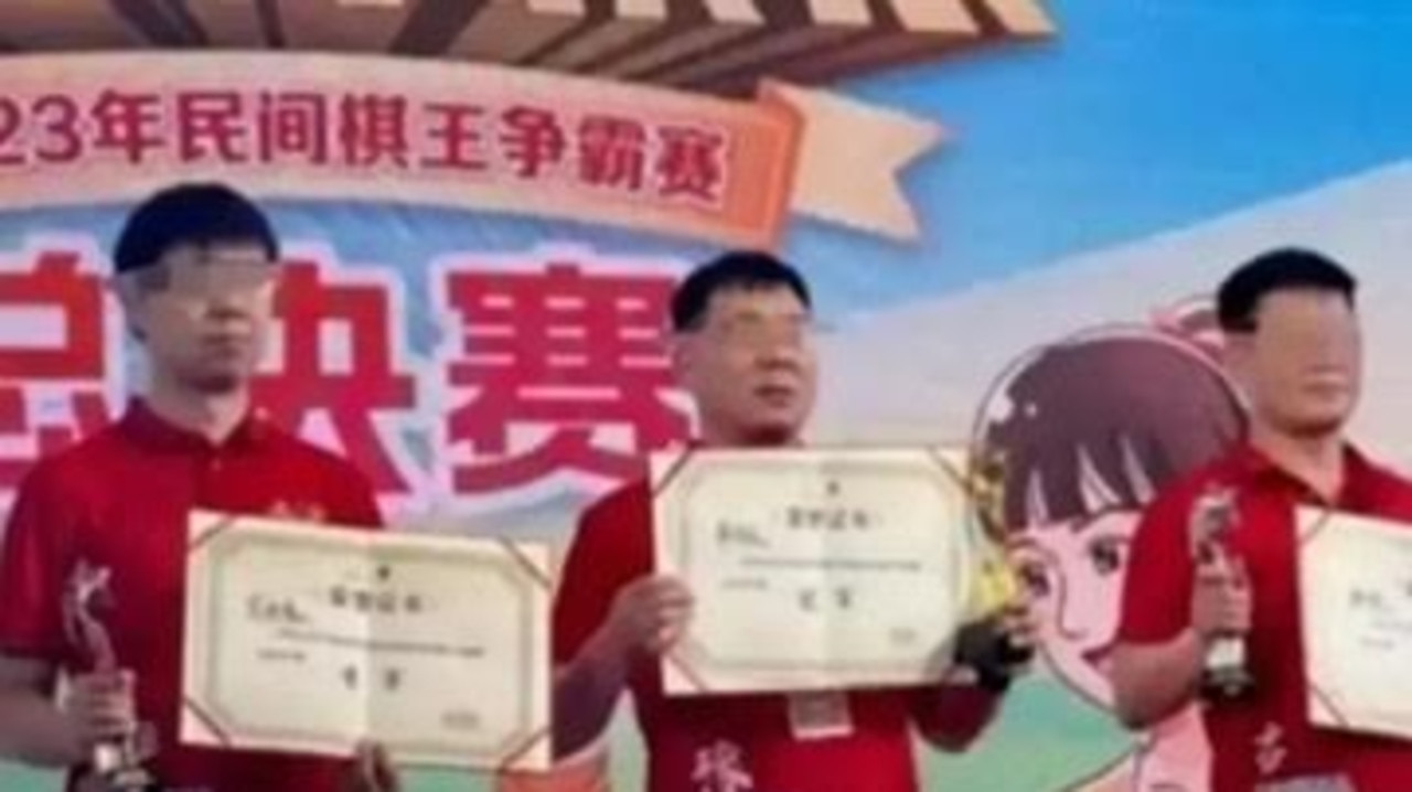 Yan (centre) flanked by two runners up, proudly holding up his prize certificate before an alleged act saw him stripped of his title. Picture: CXA