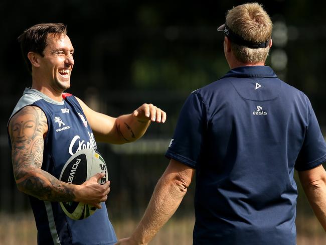 Mitchell Pearce is all smiles as he talks to coach Trent Robinson at training. Picture: Gregg Porteous