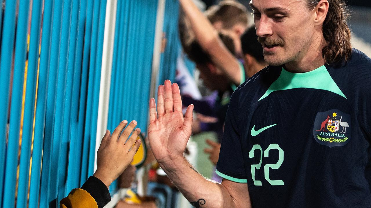 Jackson Irvine celebrates with a fan after the Socceroos’ win over Bahrain. Picture: Martin Dokoupil/Getty Images