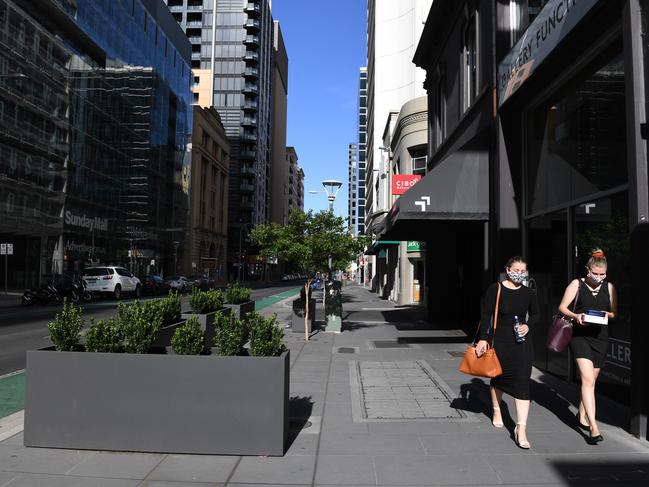 Workers Anita Schneider and Kayla Williams walk down Waymouth St on Thursday morning.. Picture: Tricia Watkinson