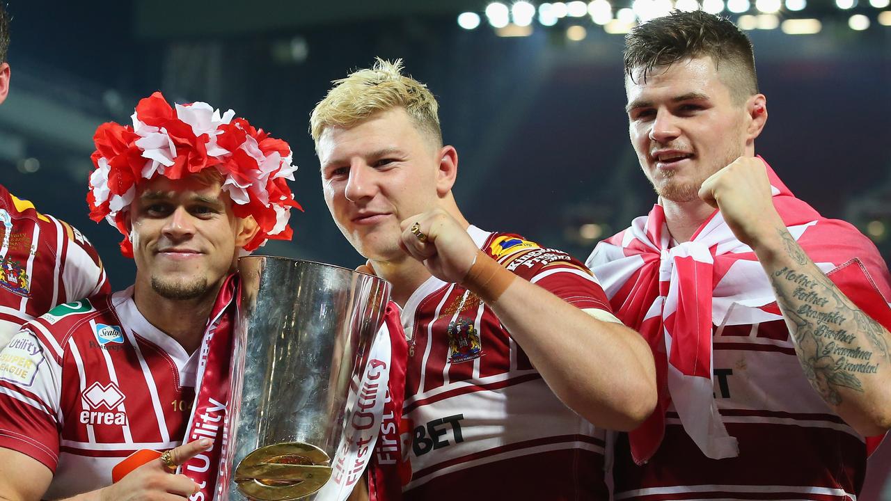 Lewis Tierney, George Williams and John Bateman celebrate victory in the 2016 grand final with Wigan