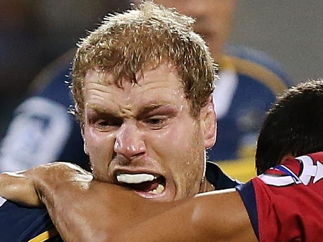 CANBERRA, AUSTRALIA - FEBRUARY 13: David Pocock of the Brumbies is tackled during the round one Super Rugby match between the Brumbies and the Reds at GIO Stadium on February 13, 2015 in Canberra, Australia. (Photo by Stefan Postles/Getty Images)