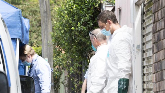 Forensic police in James Street behind the boarding house. Picture: Monique Harmer