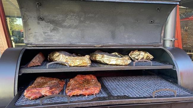 The smoker is set up outside the business’s entrance.