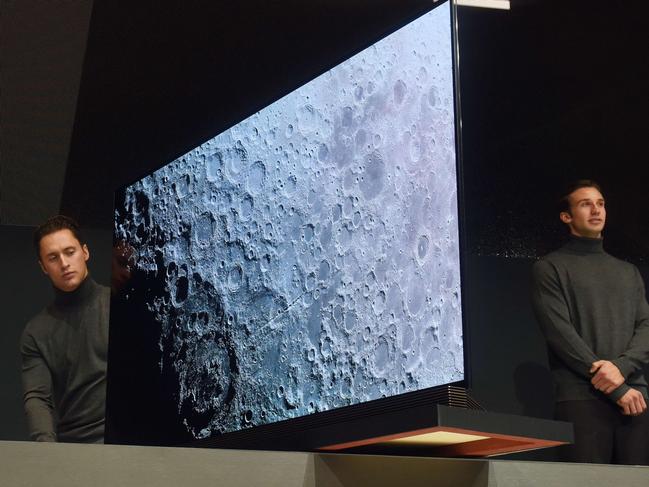 Models display the G6, LG Electronics (LG)'s newest flagship 4K HDR-enabled, 77-inch OLED TV which boasts an ultra-thin 2.57mm OLED panel with a translucent glass back and forward-facing sound bar speaker system, at a press conference on CES Press Day, January 5, 2016 in Las Vegas, Nevada ahead of the CES 2016 Consumer Electronics Show. AFP PHOTO / ROBYN BECK