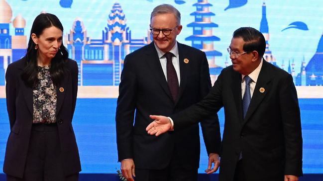 Cambodia's Prime Minister Hun Sen (R) gestures next to Jacinda Ardern (L) and Anthony Albanese (C) on stage as part of the announcement on the conclusion of negotiations upgrading the ASEAN-Australia-New Zealand Free Trade Area (AANZFTA) during the 40th and 41st Association of Southeast Asian Nations (ASEAN) Summits in Phnom Penh. Picture: AFP.