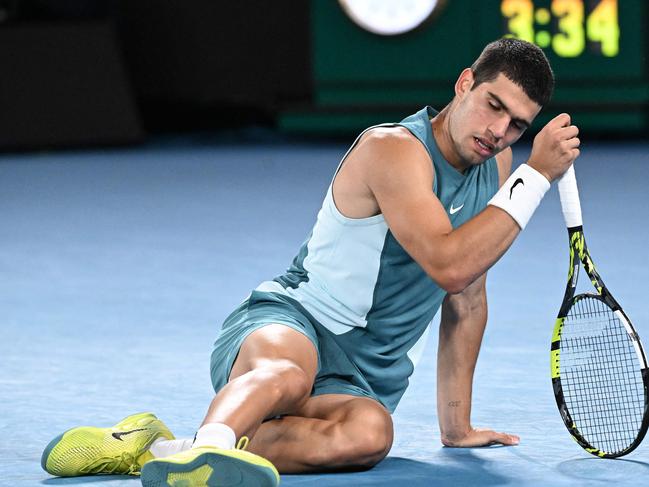 Spain's Carlos Alcaraz falls on the court in his quarterfinal defeat to Novak Djokovic. Picture: WILLIAM WEST / AFP