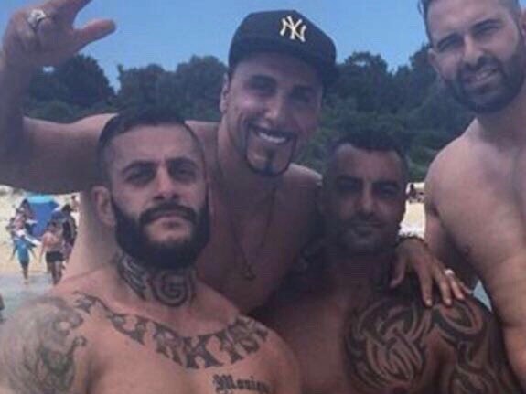 Yusuf Nazlioglu (left) poses for a photo with Mick Hawi (middle with shoulder tattoo), whose murder he was later acquitted of.