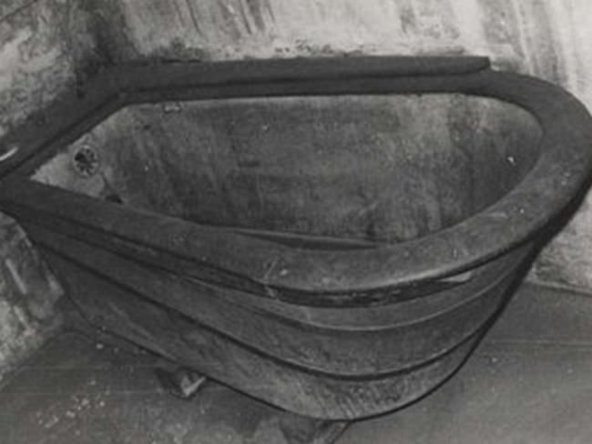 One of the baths at the hospital was made of wood with a hand pump at the back for filling.