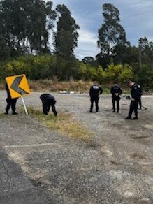 Police search an area near the intersection of Wakefield and Sugarloaf Range roads on August 11, 2022 as part of an investigation into the kneecapping of a Nomads bikie nominee.