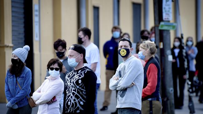 People queue at the COVID testing centre next to the Palais Theatre at St Kilda. Picture: Andrew Henshaw