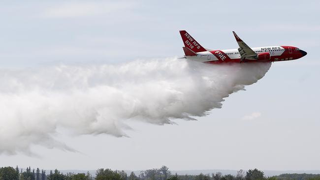 SYDNEY, AUSTRALIA - OCTOBER 23: The RFS Marie Bashir 737 Large Air Tanker (LAT) drops water during a demonstration flight at RAAF Base Richmond on October 23, 2020 in Sydney, Australia. The NSW RFS aerial firefighting fleet is the largest of any fire agency in Australia. (Photo by Ryan Pierse/Getty Images)