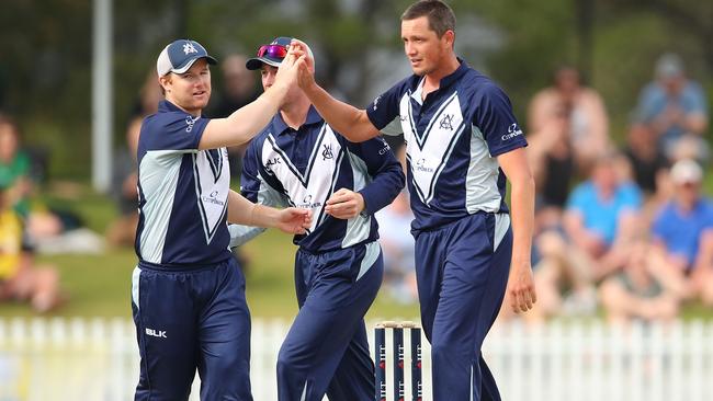 Chris Tremain of Victoria is congratulated by Travis Dean after dismissing Marcus Stoinis