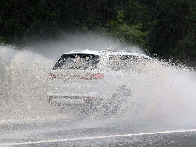 BRISBANE, AUSTRALIA - NewsWire Photos MARCH 29, 2025: Cars drive through flooded streets in Morningside after heavy showers fell in Brisbane on Saturday as parts of Northern Queensland experienced major flooding. Picture: NewsWire/Tertius Pickard