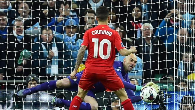 Manchester CIty's Argentinian goalkeeper Willy Caballero (R) saves.