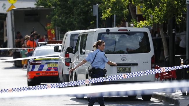 Police close down streets around the crime scene. Picture: David Swift.