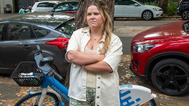 Nurse Molly Fallon has the dumped bikes make it difficult to negotiate the footpath. Picture: Thomas Lisson